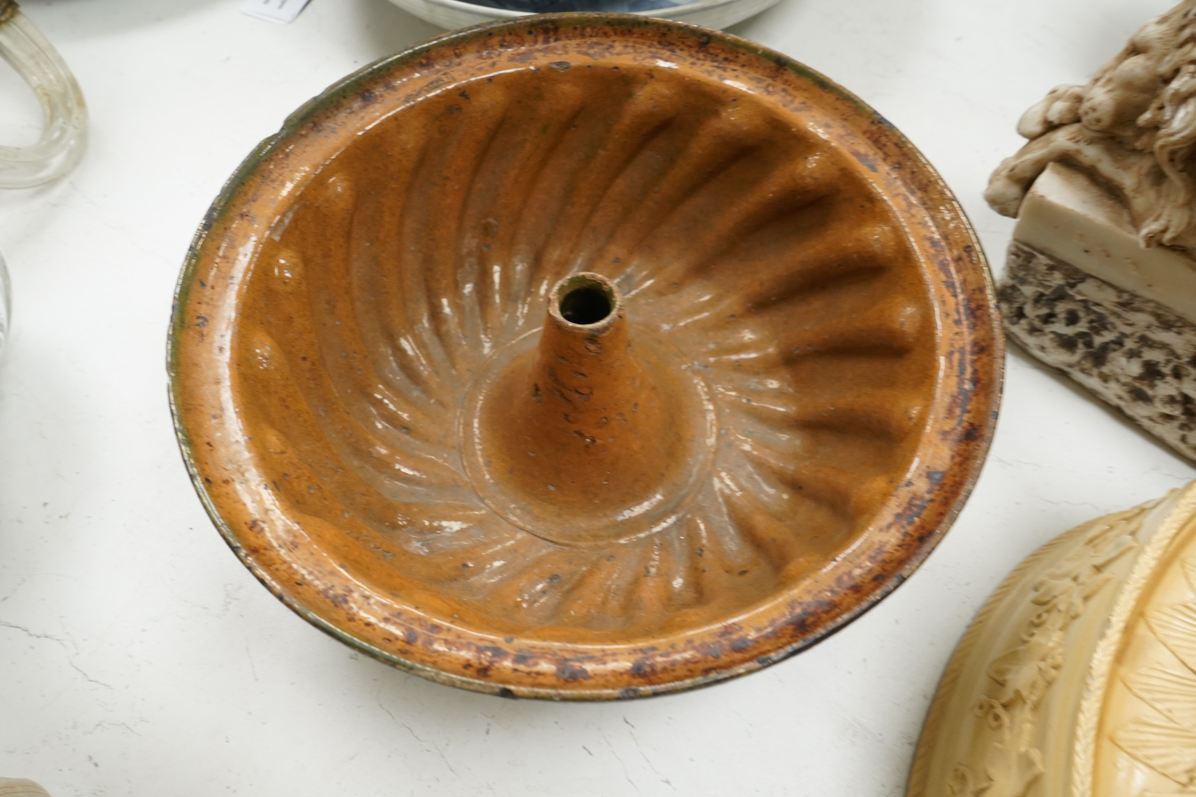 A 19th century oval caneware game/pie dish and cover, 24cm wide with an antique cake mould, (2)
